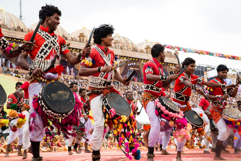 A group of men play drums and dance during a performance at World Culture Festival